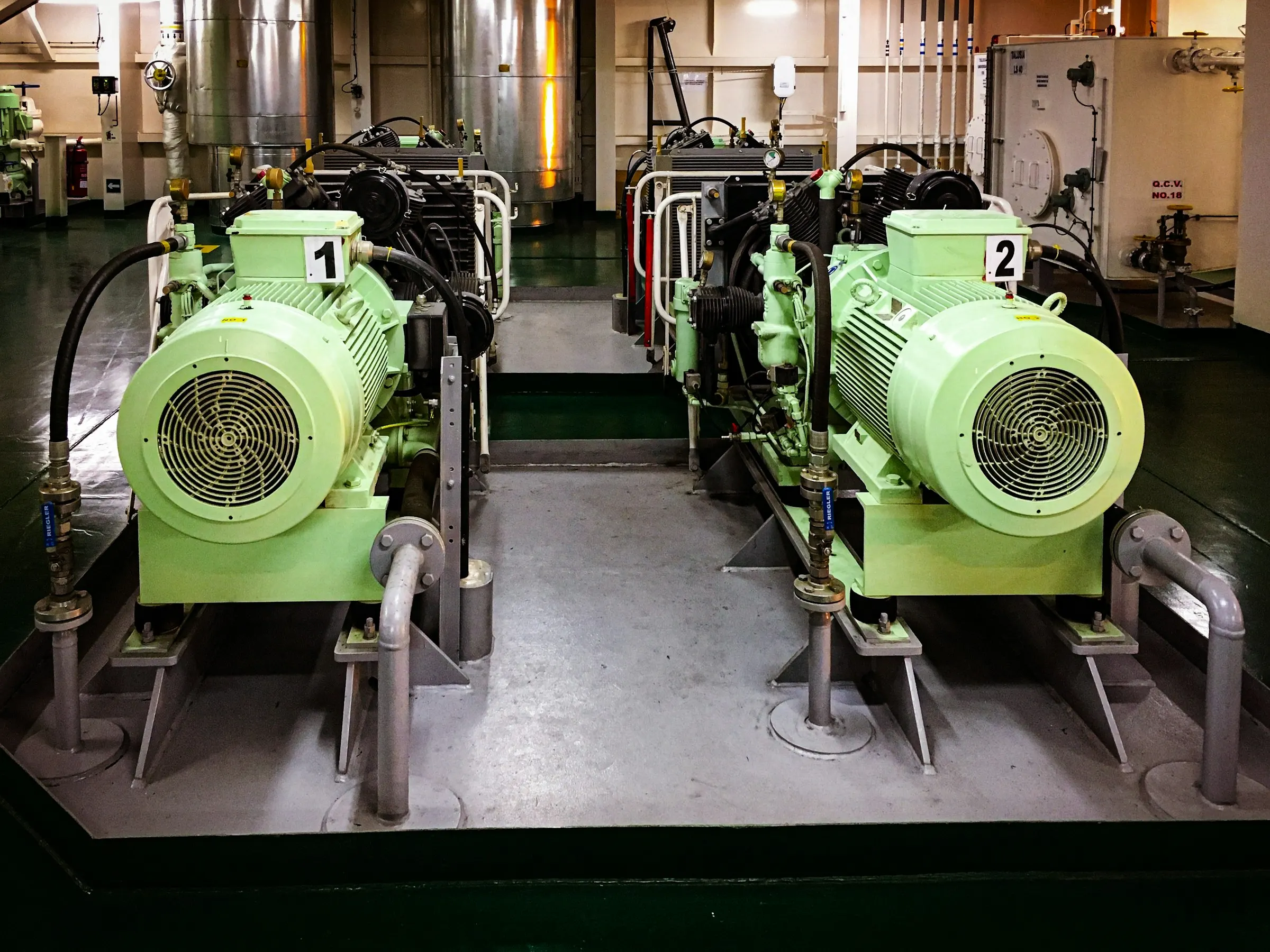 Photograph: two motor-driven compressors in an engine room.